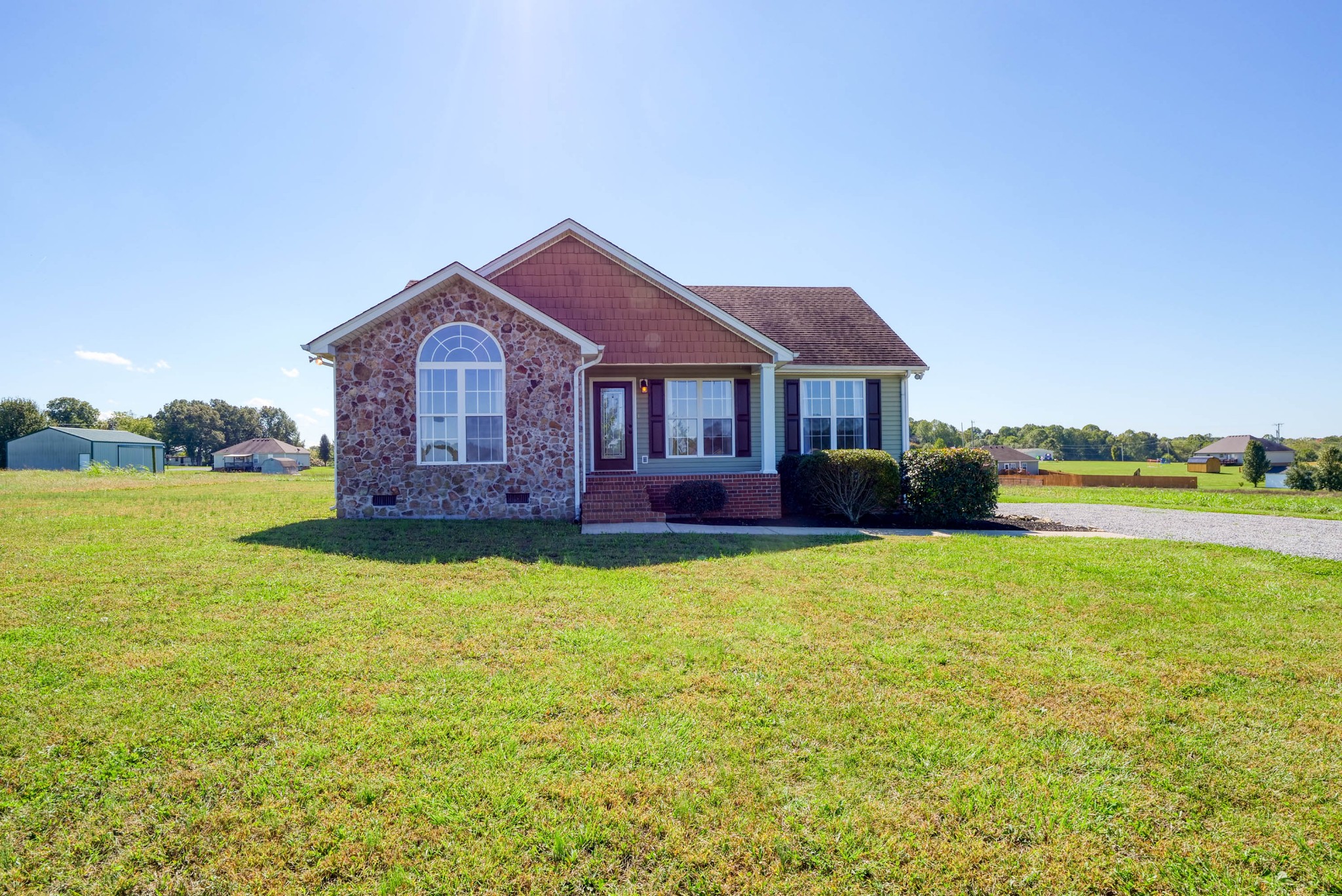 724 Lear Road Portland, TN 37148 - Photo 1 of 32 a front view of a house with a yard and lake view