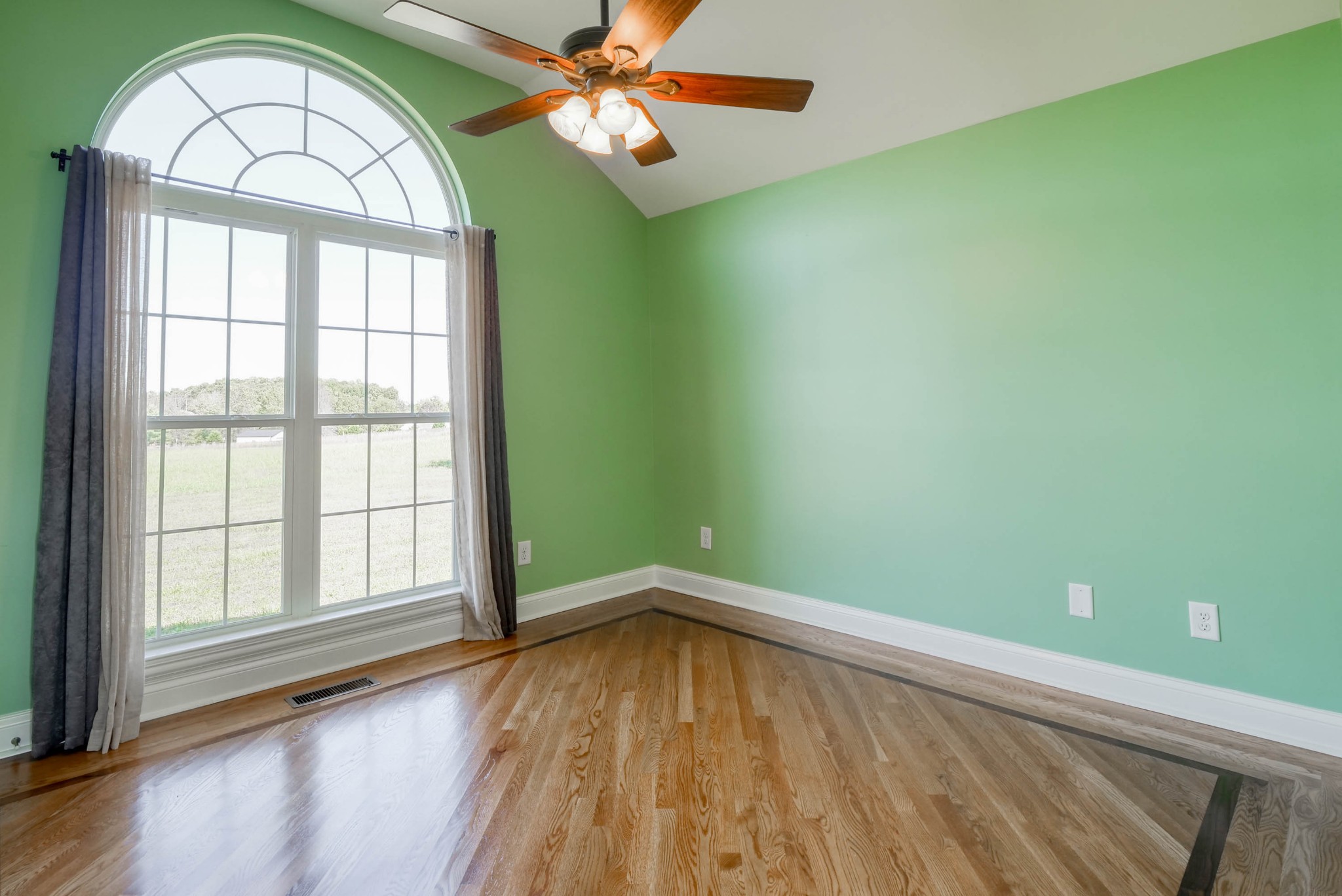 724 Lear Road Portland, TN 37148 - Photo 15 of 32 an empty room with a window and wooden floor