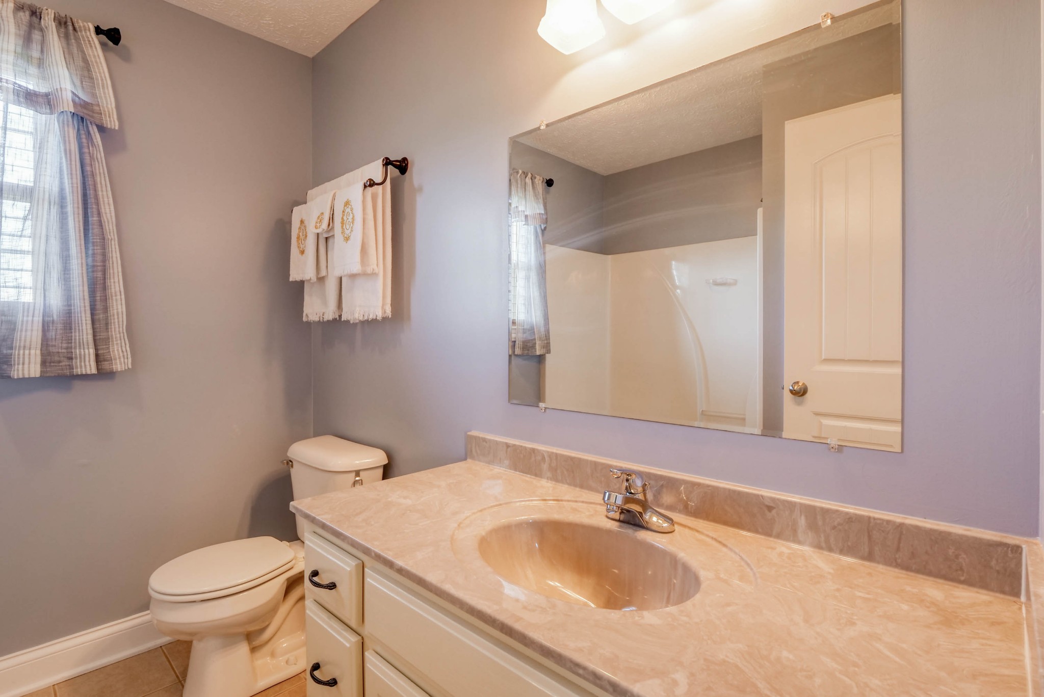 724 Lear Road Portland, TN 37148 - Photo 20 of 32 a bathroom with a sink toilet and mirror