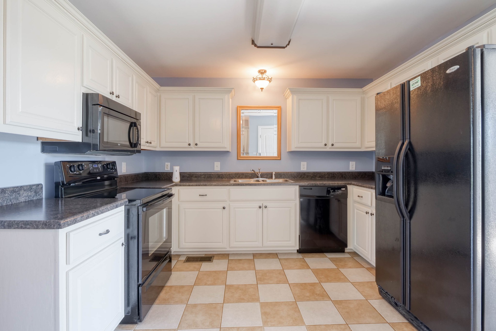 724 Lear Road Portland, TN 37148 - Photo 9 of 32 a kitchen with stainless steel appliances granite countertop a refrigerator a sink a stove a microwave and island