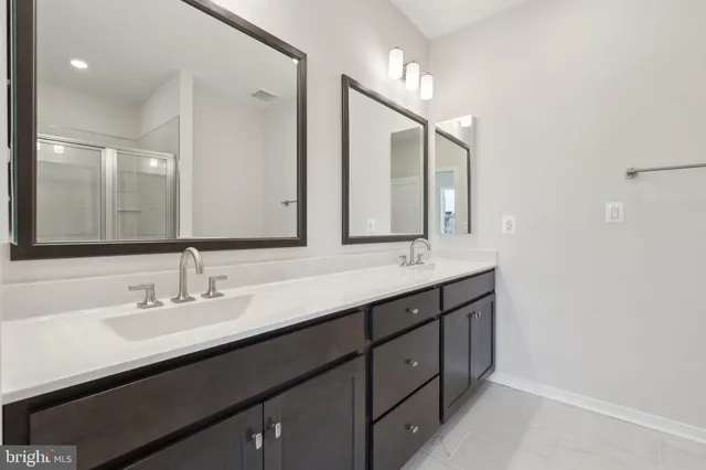 a bathroom with a double vanity sink and a mirror