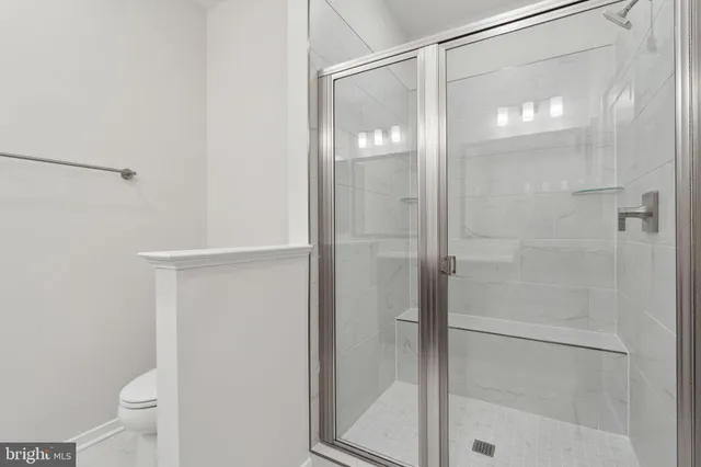 a bathroom with a glass shower door