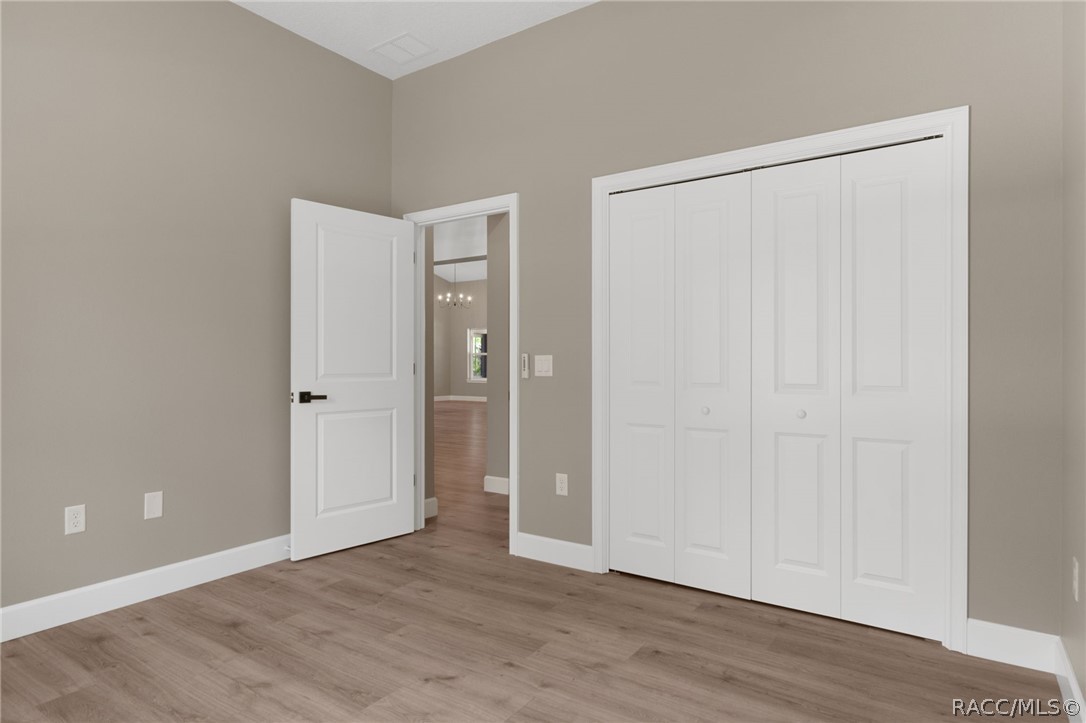 4530 South Florida Avenue Inverness, FL 34450 - Photo 28 of 100 a view of an empty room with wooden floor and closet