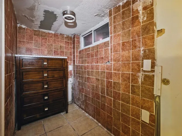 a bathroom with a shower and a mirror