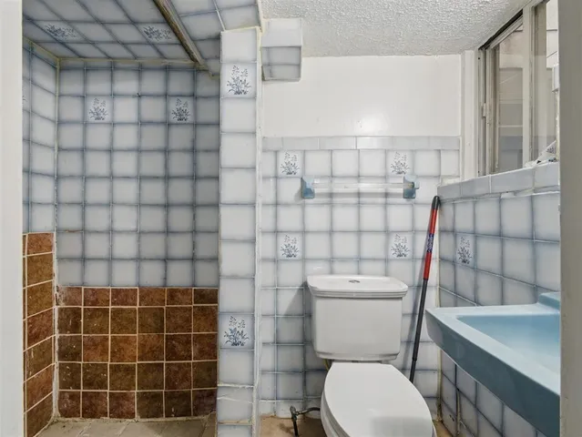 a white toilet sitting next to a bathroom sink
