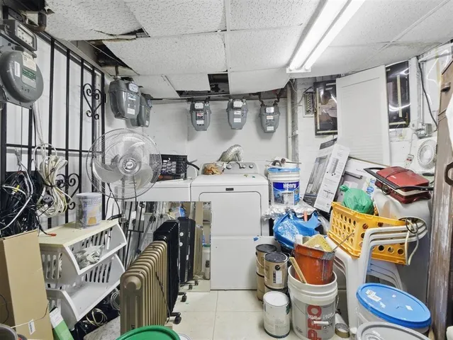 a utility room with fridge dryer and washer