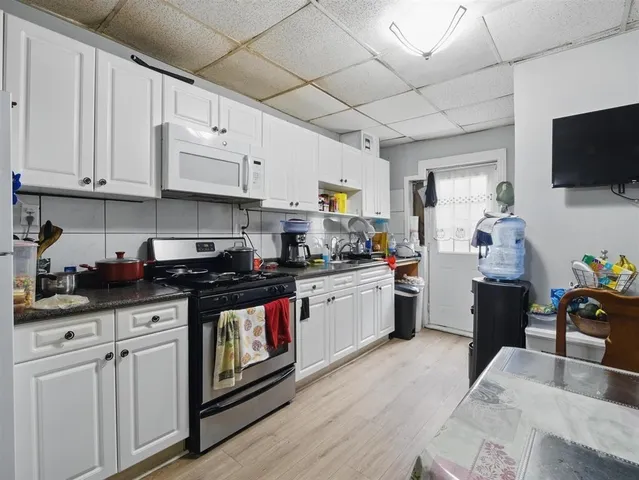 a kitchen with stainless steel appliances granite countertop a stove and cabinets