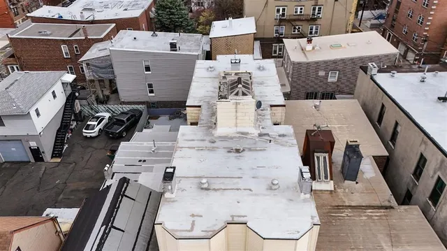 an aerial view of residential houses with outdoor space