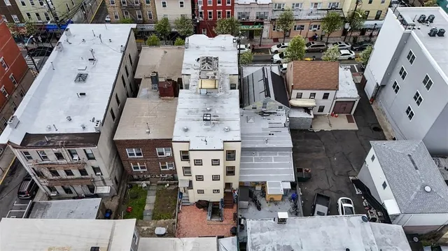 an aerial view of multiple houses with outdoor space