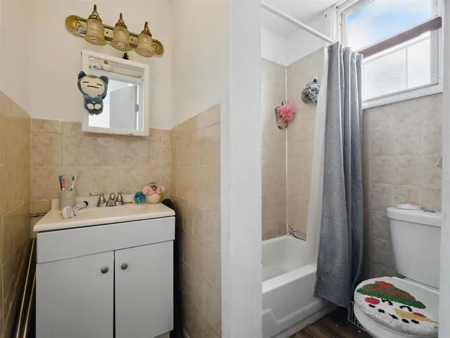 a bathroom with a sink mirror and toilet