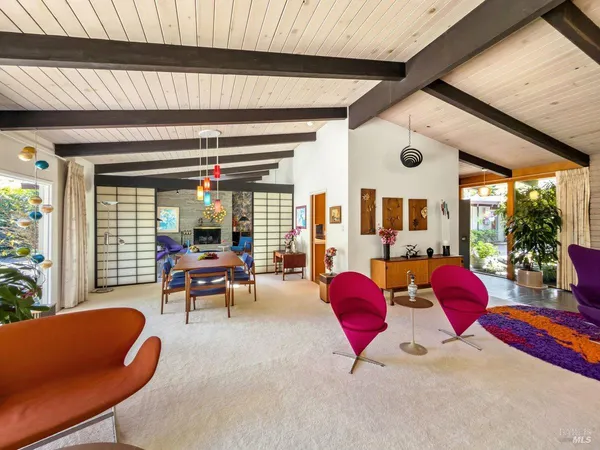 a living room with furniture and floor to ceiling window