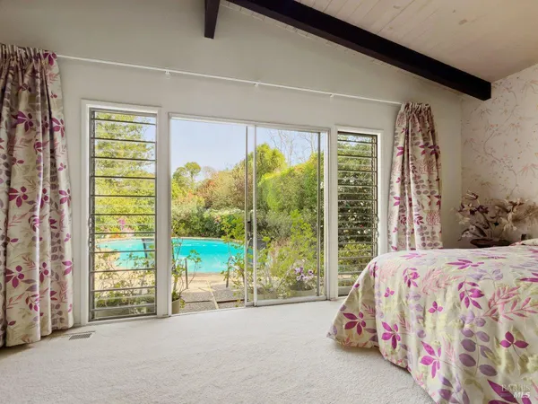 a bedroom with a bed and a potted plant