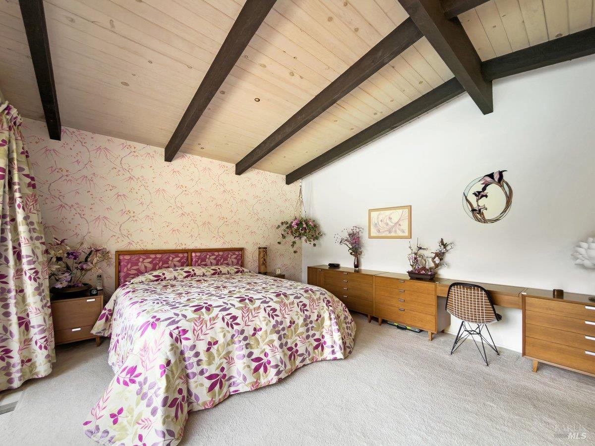 5 Mather Road San Anselmo, CA 94960 - Photo 18 of 58 a bedroom with a bed and a chandelier