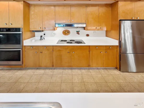 a view of a refrigerator in kitchen and wooden floor