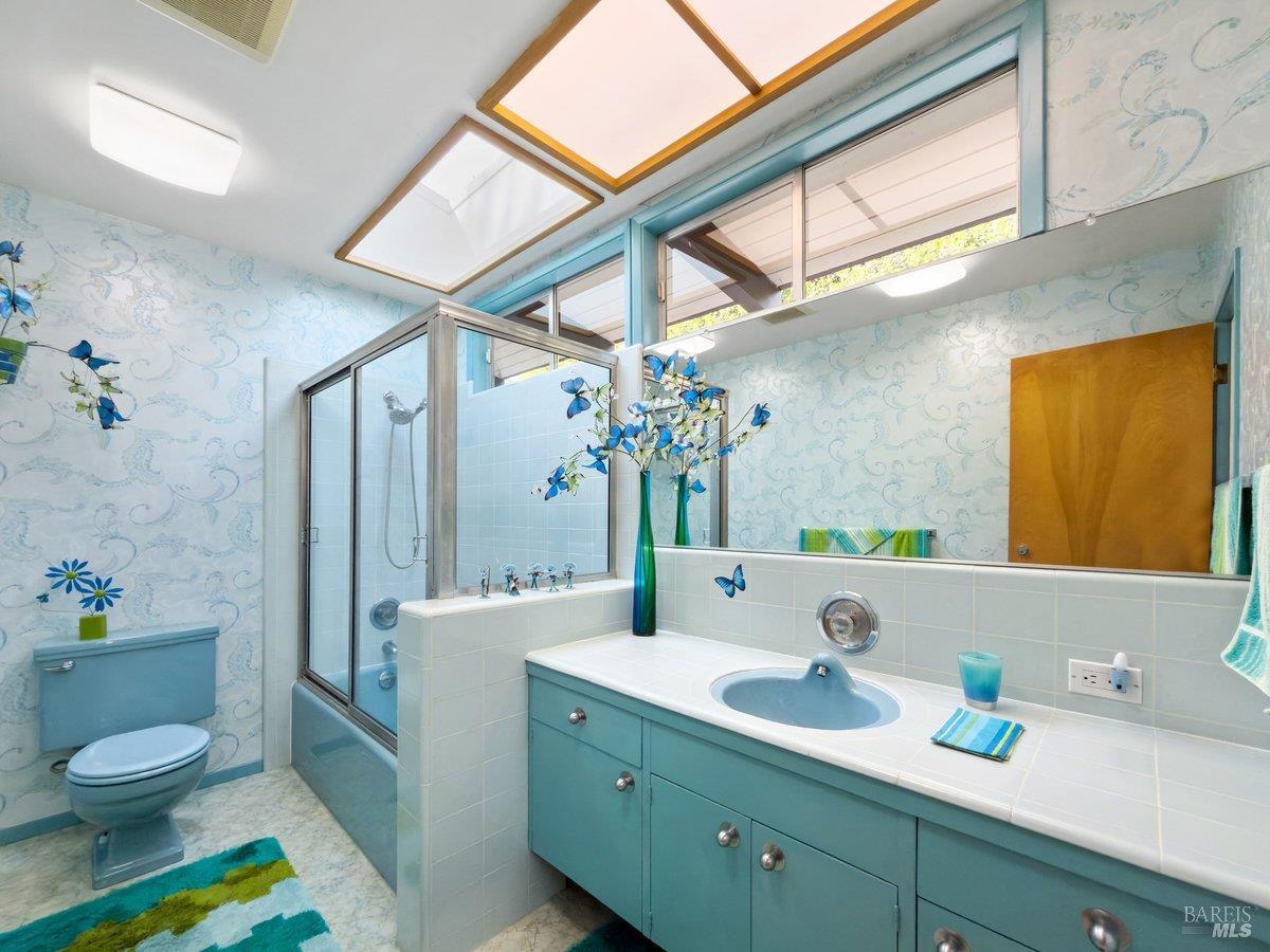 5 Mather Road San Anselmo, CA 94960 - Photo 30 of 58 a bathroom with a granite countertop sink mirror vanity and toilet