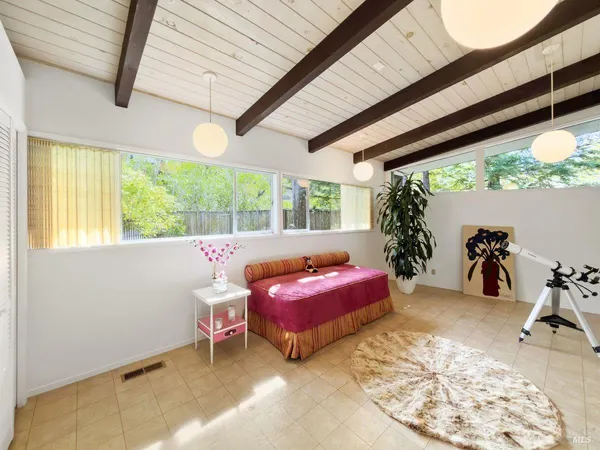 a view of the patio with dining table and chairs with wooden floor and fence
