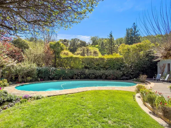 a view of a swimming pool with an outdoor space and seating area