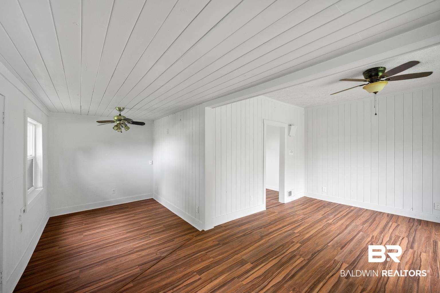 19575 Keller Road Foley, AL 36535 - Photo 4 of 17 Spare room with ceiling fan, wood finished floors, wood ceiling, and wood walls