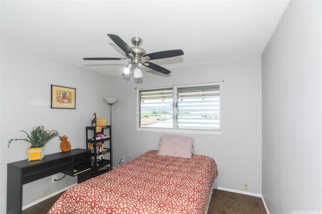 a bedroom with a bed a dresser and a window