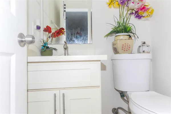 a bathroom with a toilet sink and mirror