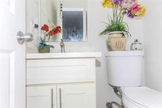 a bathroom with a toilet sink and mirror
