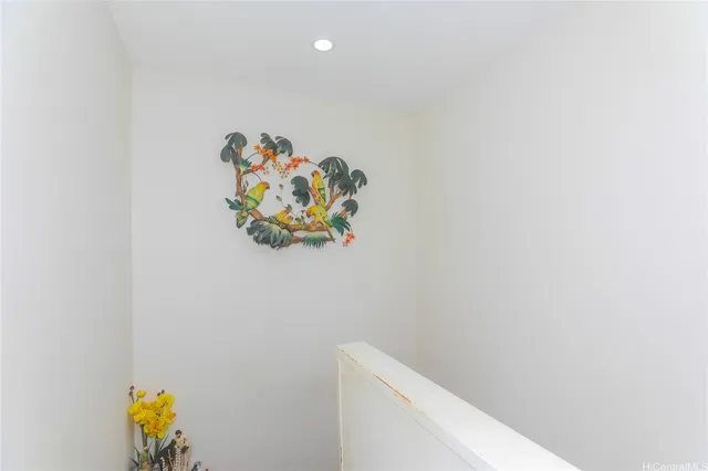 a white wall with a painting on it and a wall