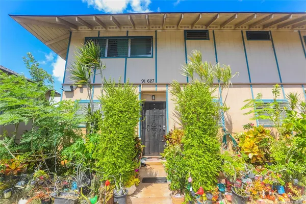 a potted plant sitting in front of a house