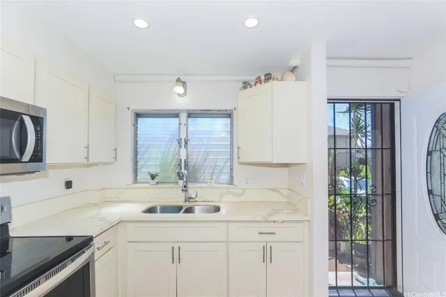 a kitchen with a sink dishwasher a stove and a refrigerator
