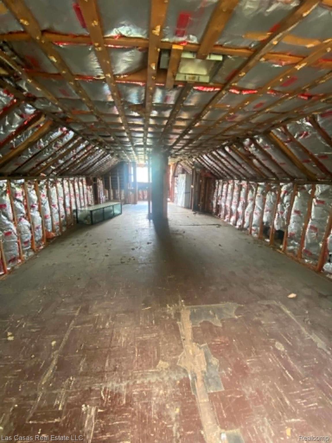 7545 Holmes Street Detroit, MI 48210 - Photo 10 of 12 Spacious attic area featuring exposed ceiling joists and visible insulation