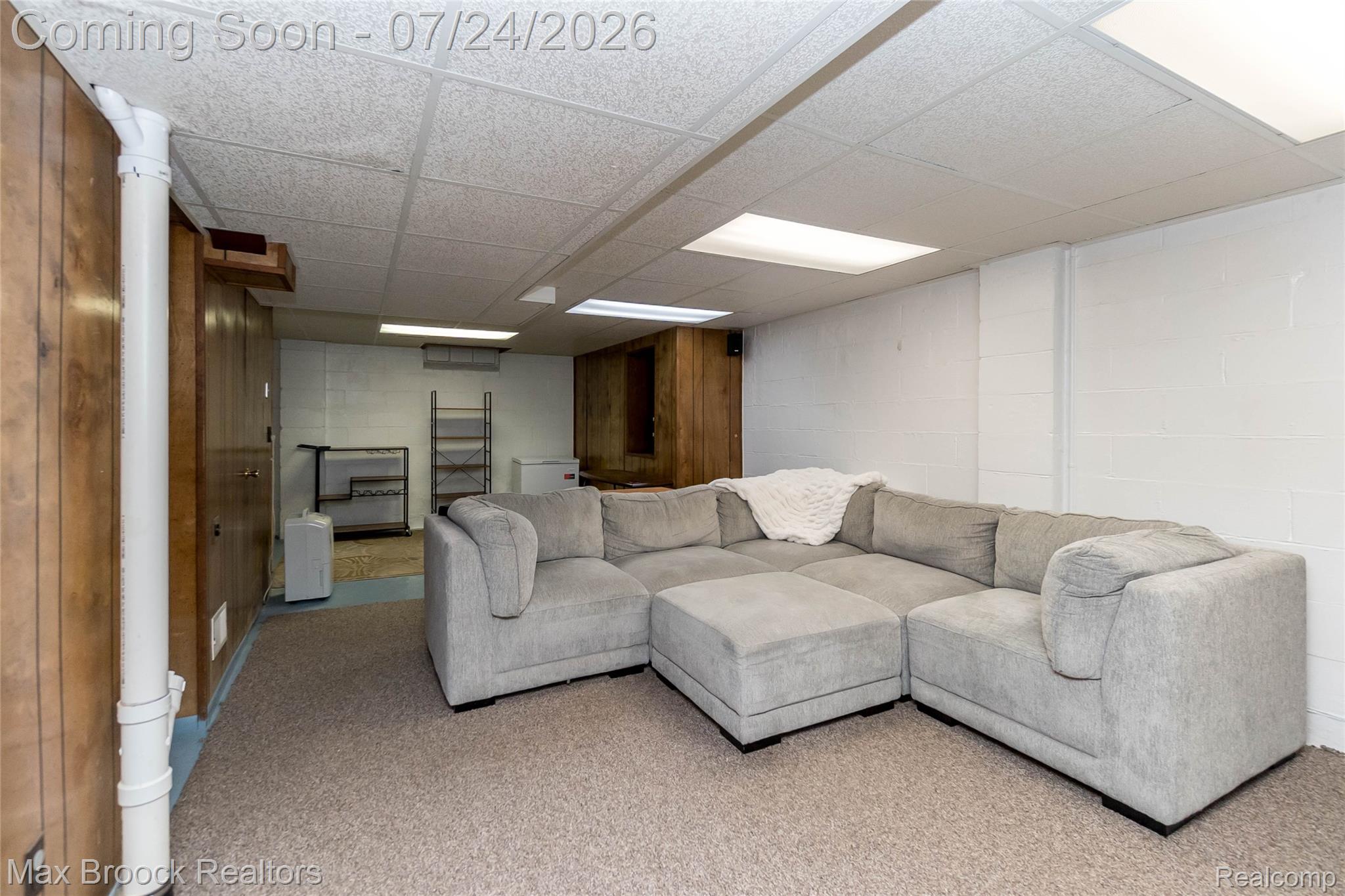 1090 Cambridge Road Berkley, MI 48072 - Photo 23 of 43 Finished basement space featuring wood paneling, white painted block walls, and drop ceiling with integrated lighting