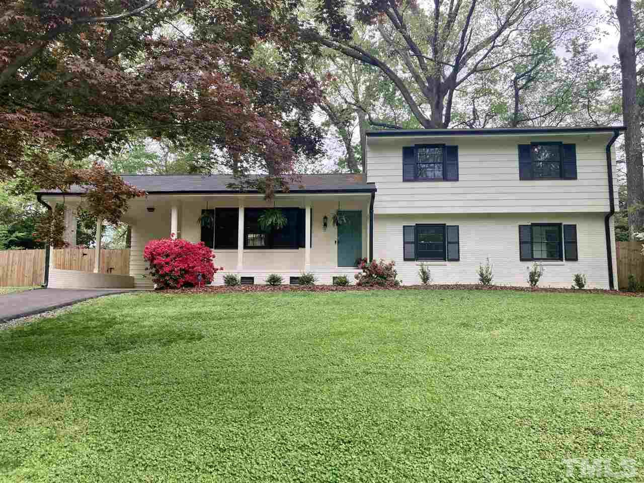6408 Johnsdale Road Raleigh, NC 27615 - Photo 1 of 29 a front view of a house with a garden