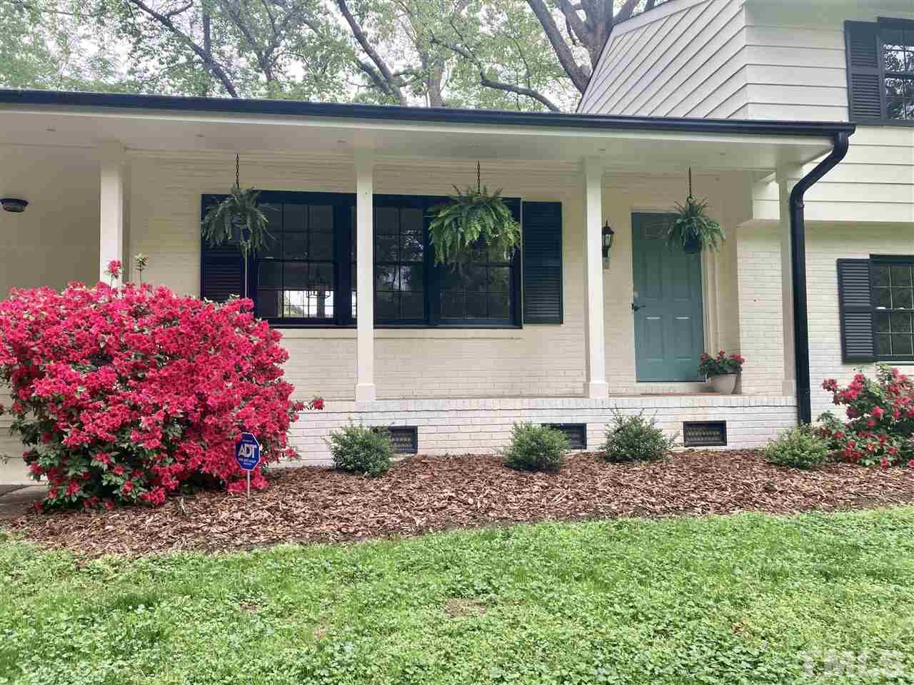 6408 Johnsdale Road Raleigh, NC 27615 - Photo 2 of 29 a front view of a house with a garden