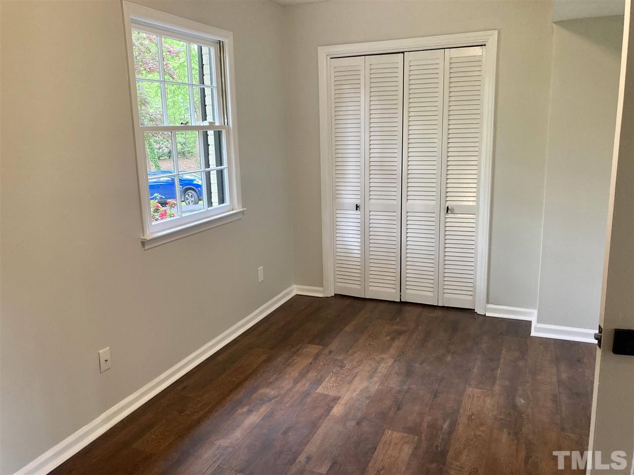 6408 Johnsdale Road Raleigh, NC 27615 - Photo 11 of 29 an empty room with wooden floor and windows