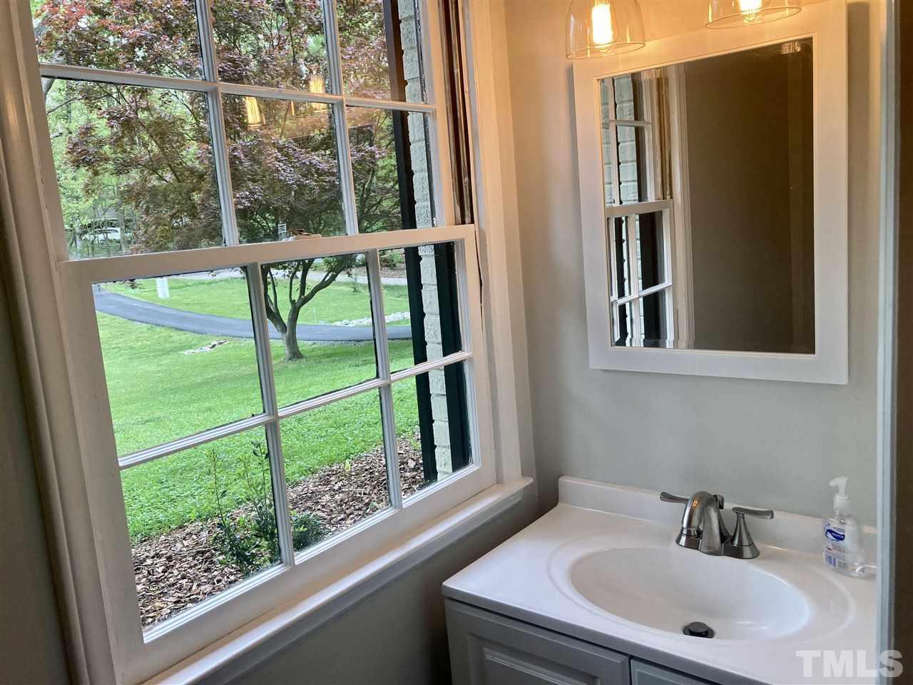 6408 Johnsdale Road Raleigh, NC 27615 - Photo 13 of 29 a bathroom with a sink and a mirror