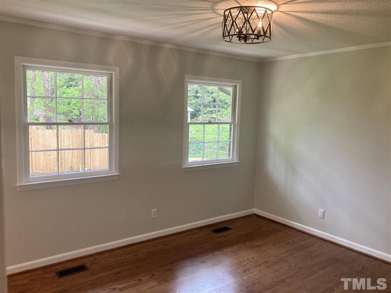 6408 Johnsdale Road Raleigh, NC 27615 - Photo 14 of 29 an empty room with wooden floor and a window
