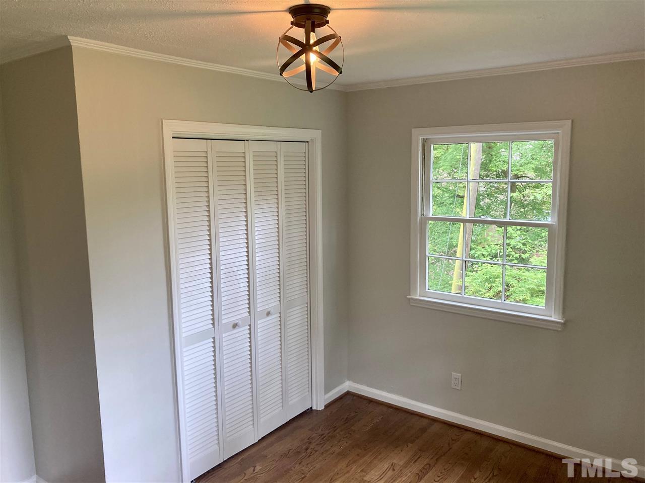 6408 Johnsdale Road Raleigh, NC 27615 - Photo 17 of 29 a view of empty room with wooden floor and fan