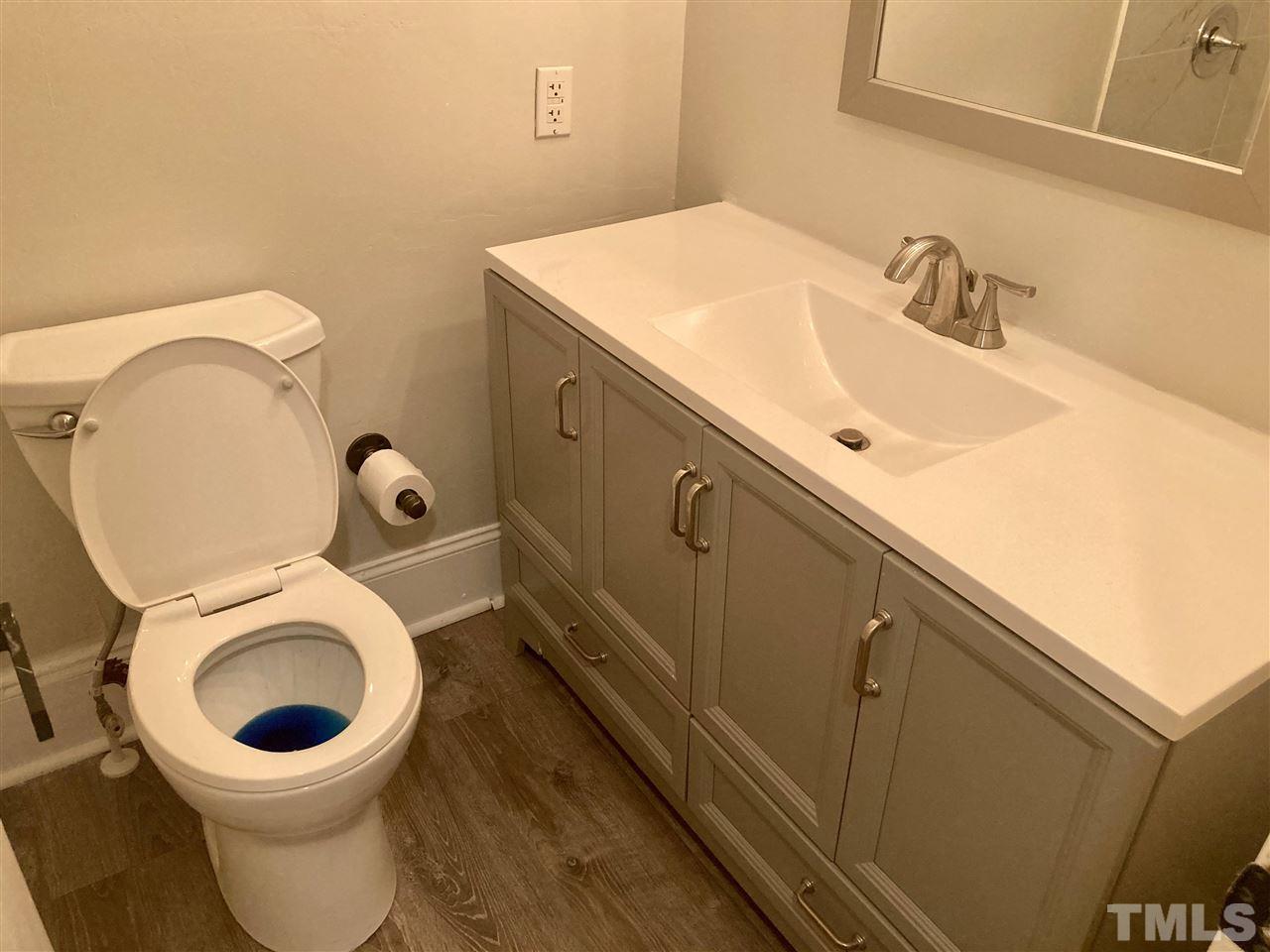 6408 Johnsdale Road Raleigh, NC 27615 - Photo 18 of 29 a bathroom with a toilet sink and mirror