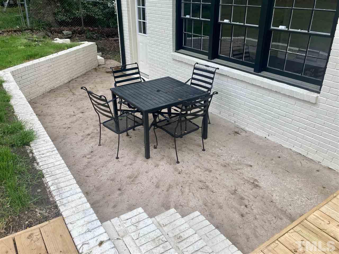 6408 Johnsdale Road Raleigh, NC 27615 - Photo 21 of 29 a view of a patio with a table and chairs