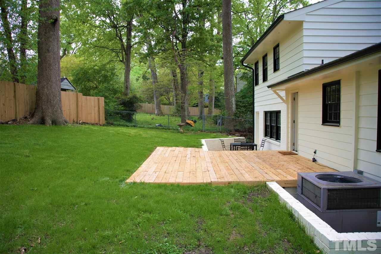 6408 Johnsdale Road Raleigh, NC 27615 - Photo 22 of 29 a view of a backyard with table and chairs and a barbeque