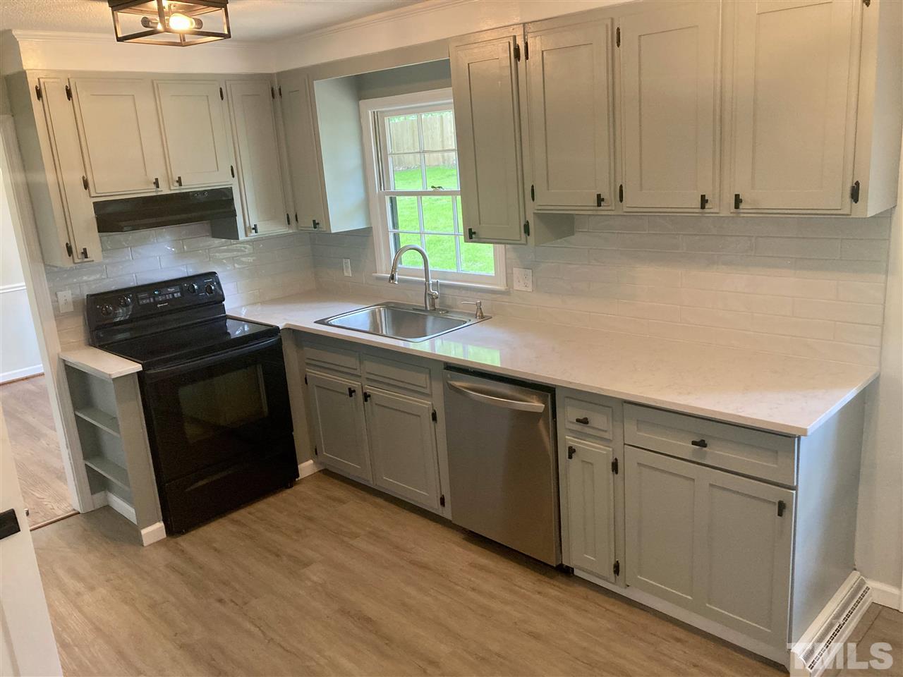 6408 Johnsdale Road Raleigh, NC 27615 - Photo 7 of 29 a kitchen with appliances cabinets and a sink