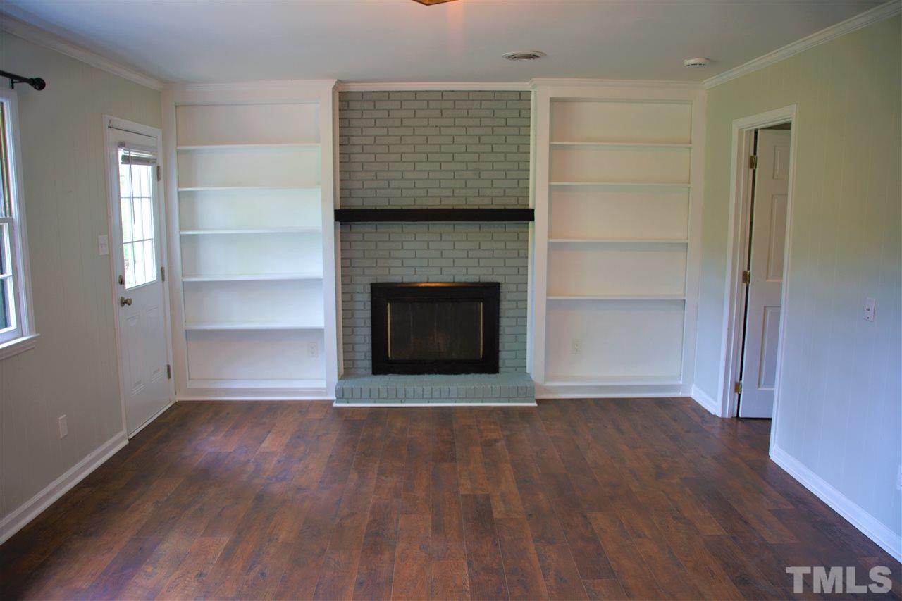 6408 Johnsdale Road Raleigh, NC 27615 - Photo 9 of 29 a view of an empty room with wooden floor and a window