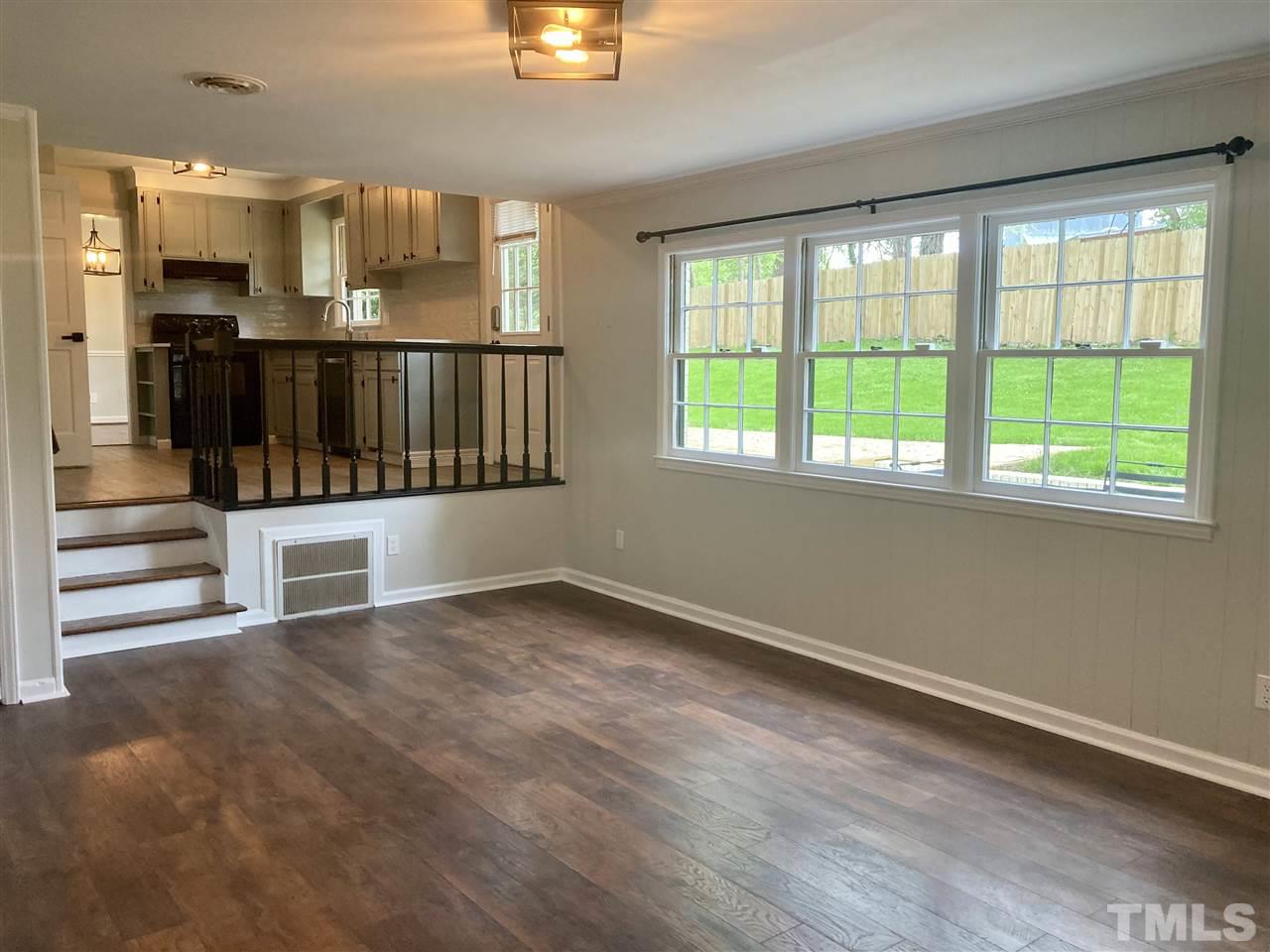 6408 Johnsdale Road Raleigh, NC 27615 - Photo 10 of 29 an empty room with wooden floor and windows