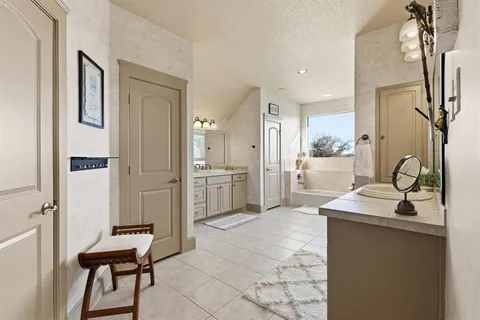 a spacious bathroom with a bathtub and a shower