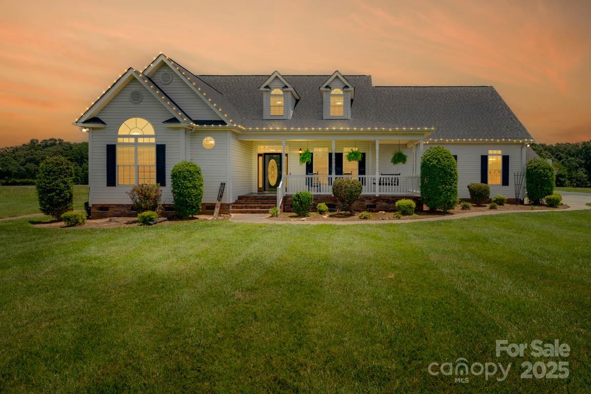 a front view of house with yard outdoor seating and green space