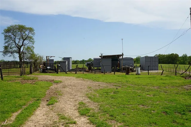 a view of a big yard with a table and chairs