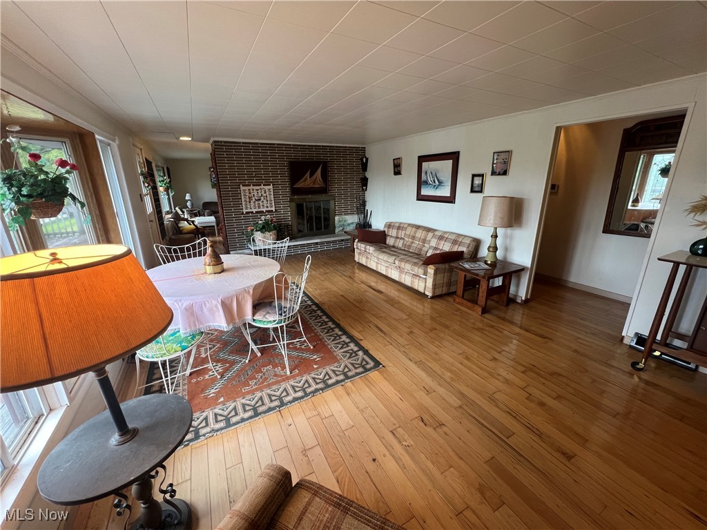 86610 Beaver Dam Road Scio, OH 43988 - Photo 25 of 50 Living room with hardwood / wood-style floors, plenty of natural light, and a brick fireplace