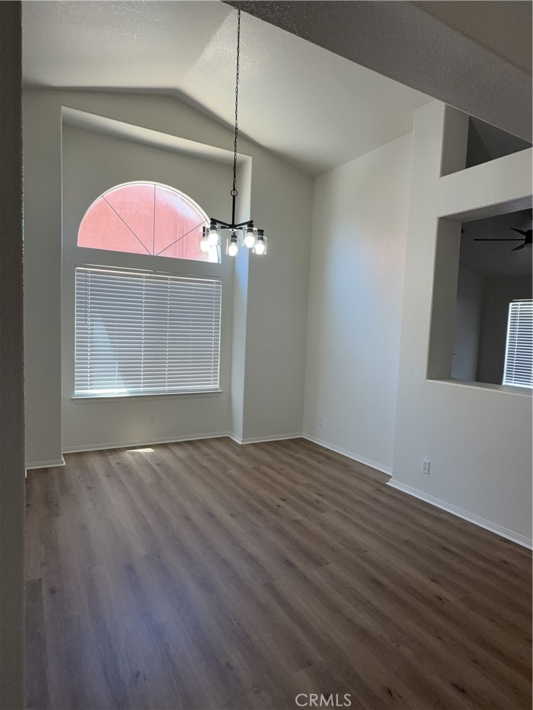 12590 Cobalt Road Victorville, CA 92392 - Photo 12 of 37 an empty room with wooden floor fan and window