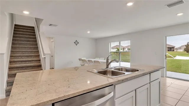 a kitchen with a sink and a refrigerator