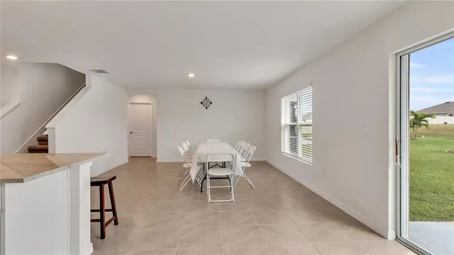 a dining room with furniture and window