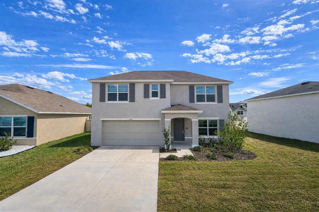16614 Windmill Forge Pass Wimauma, FL 33598 - Photo 4 of 18 a front view of a house with garden